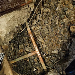 Corroded copper pipes exposed during leak repair