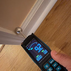 Moisture meter showing 92% moisture in hardwood floor