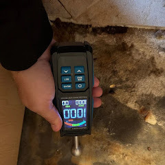 Moisture meter detecting water behind wall