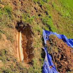 Exposed water line in excavated trench for repair